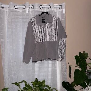 The North Face Gray and White winter camo Fleece Jacket.